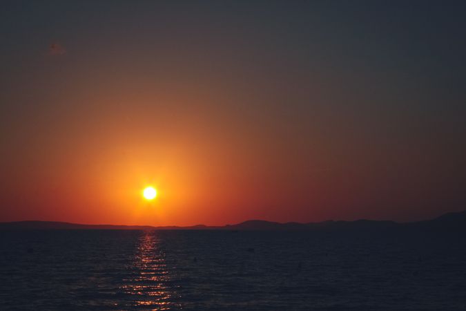 Orange sunset is on the beach. Beautiful red sunset is on the sea.