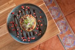 Plate with tasty tartar on table