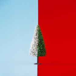 Christmas tree half with snow on duotone background