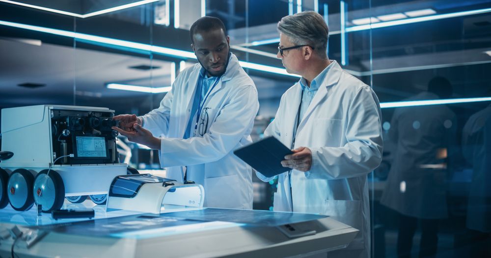 Portrait of Two Diverse Male Industrial Robotics Specialists Working on a Mobile Robot.