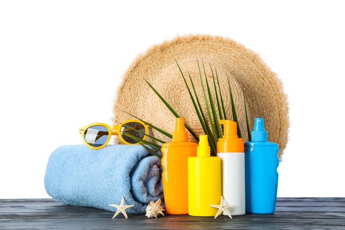 Summer vacation accessories on wooden table isolated on blank background. Happy holidays