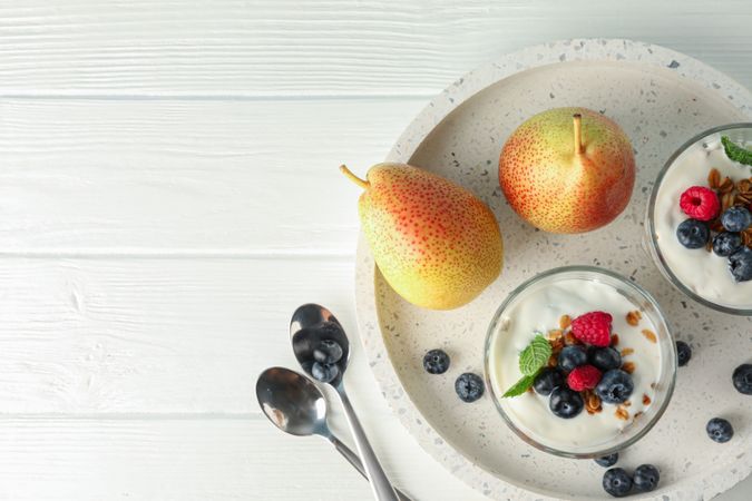 Parfaits and pears on wooden table, space for text