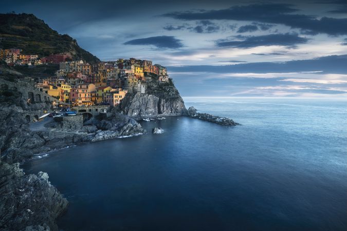 Manarola village, rocks and sea in blue hour, Cinque Terre, Italy