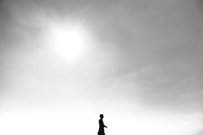 Silhouette of man walking under clear sky