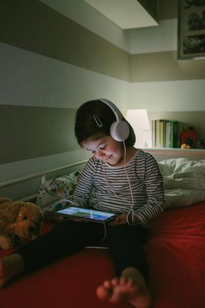 Girl with headphones looking at the tablet