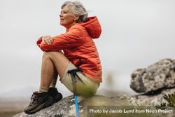 Adult woman relaxing after finishing her trek on a hill bERZo0