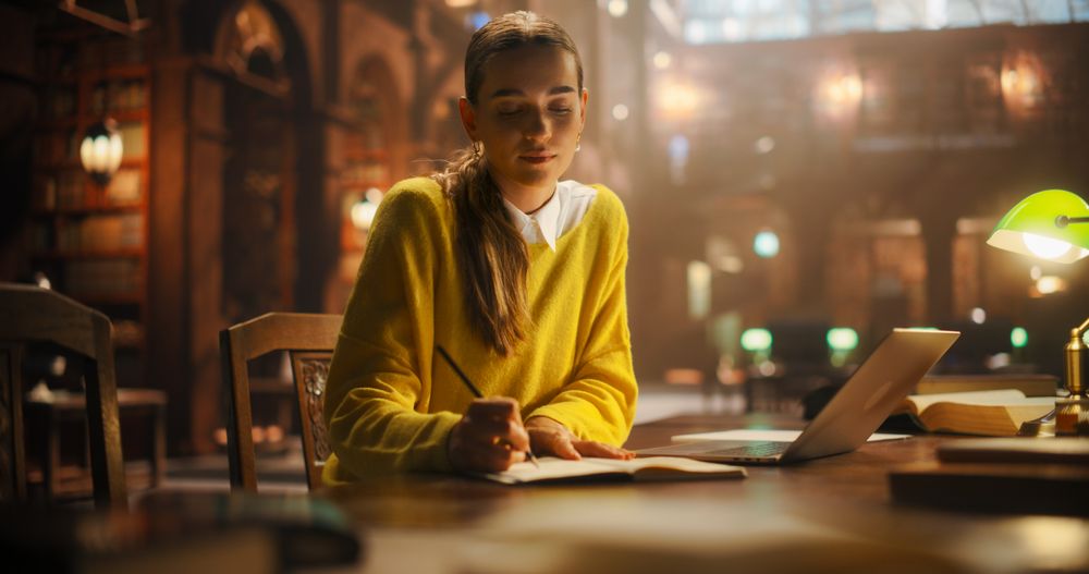 Focused Young Woman Studying In a Vintage Library