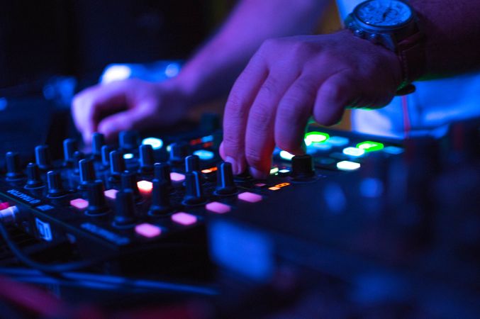 DJ playing music using audio mixer