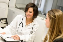 Doctor with blonde patient in clinic
