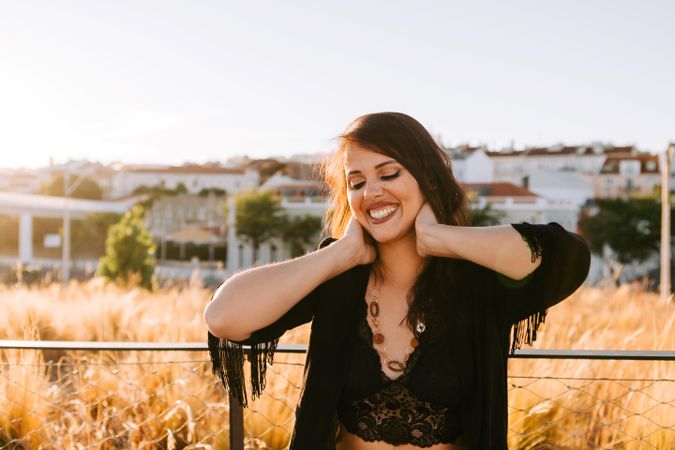 Trendy female standing on urban background
