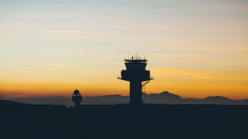 Air traffic control tower at sunset