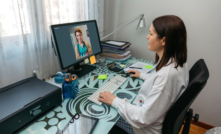 Woman talking on video call with her doctor