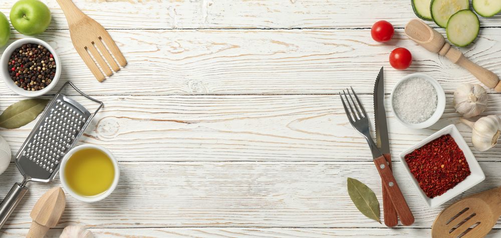 Composition with kitchen cutlery and ingredients for cooking on wooden background, top view