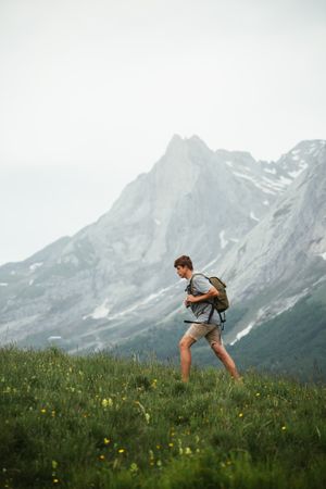 Unrecognizable man with backpack hiking in Pyrenees mountains