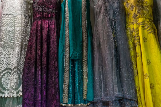 Colorful and patterned dresses hang in the market