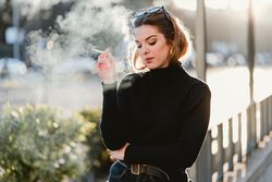 woman smoking on street