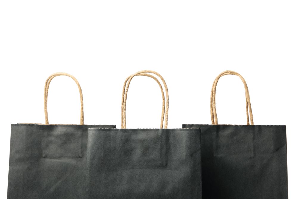 dark paper bags isolated on light background