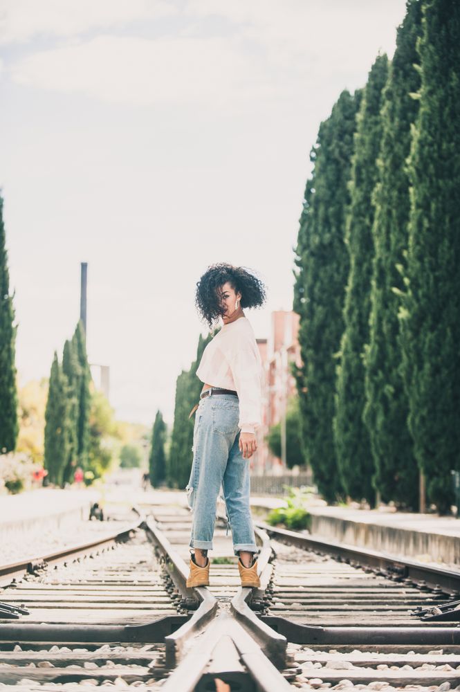 Black woman looking at camera in the tracks of a trail