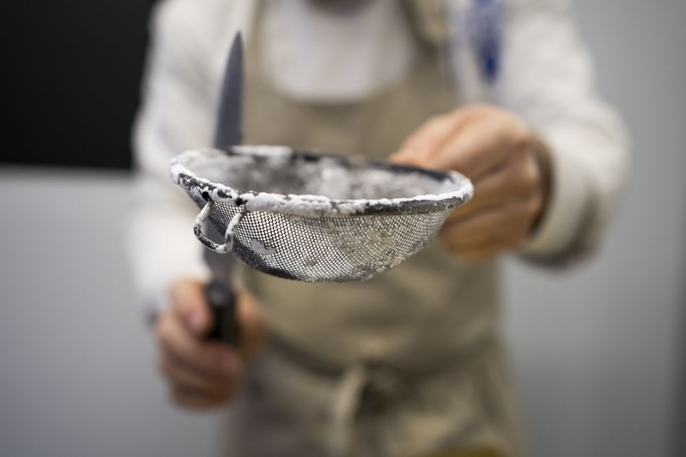 Cook sifting flour for dough