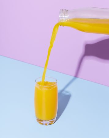 Orange juice glass on a blue table