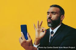 Intense Black businessman in suit gesturing at smartphone screen 43WJg4