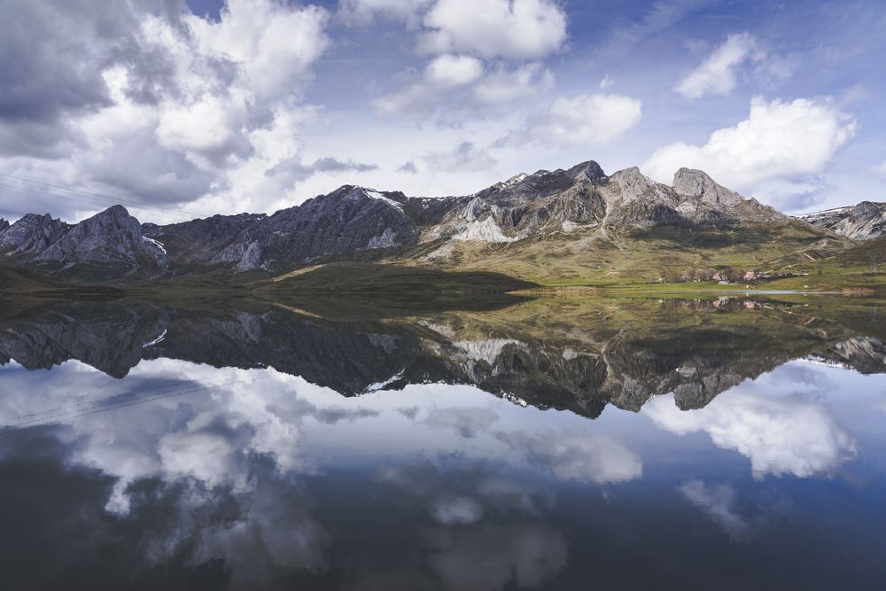 Cloudy sky over calm lake and mountains