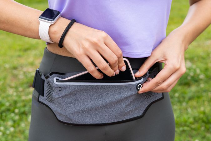 Runner woman getting fanny pack ready for running