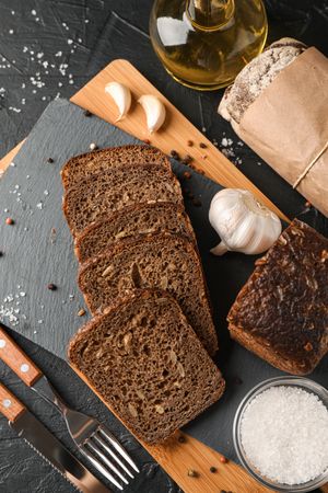 Composition with bread on cutting board, top view