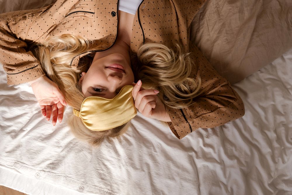 Overhead view of woman lying on bed