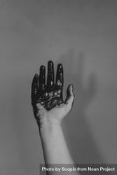 Grayscale photo of hand with dark paint 0LXJD0