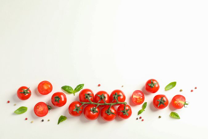 Flat lay composition with fresh cherry tomatoes, pepper and basil on blank background, space for text. Ripe vegetables