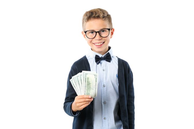 Boy holding money in his hand isolated on blank background