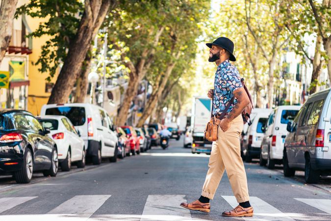Stylish Black man walking on the city street