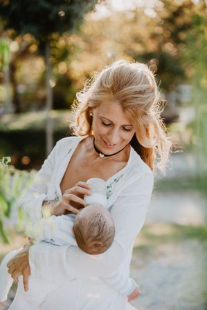 woman feeding a baby with a bottle