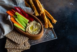 Trey with hummus, fresh veggies, rye crackers and breadsticks