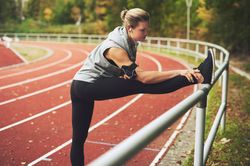 Woman stretching on athletic track