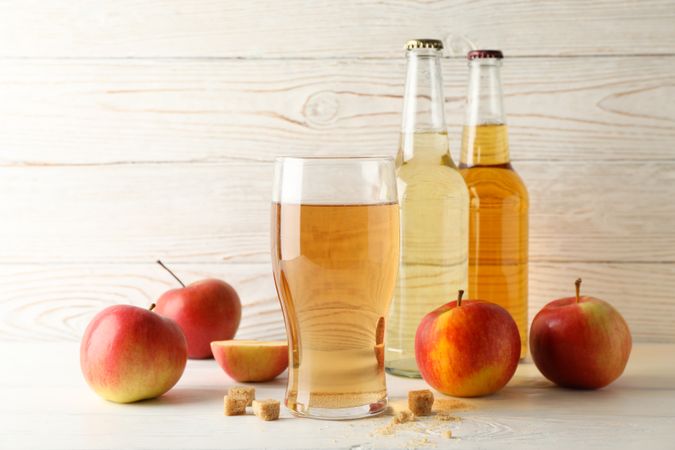 Composition with cider, sugar and apples on wooden background