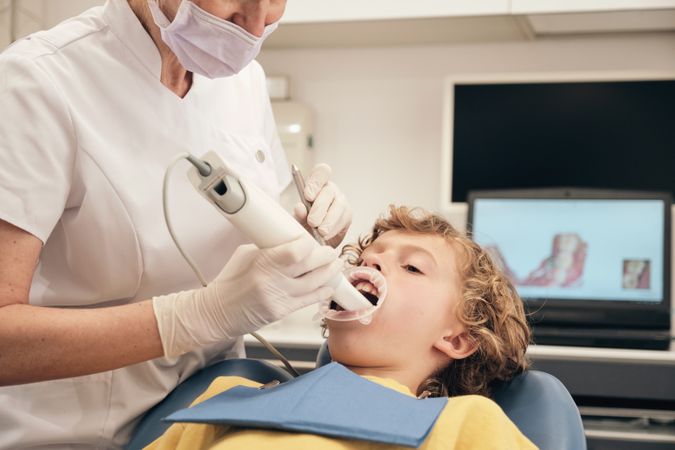 Crop dentist applying intraoral scanner for digital displaying dental casts