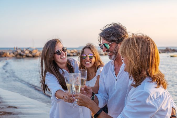 Happy family drinking wine on beach