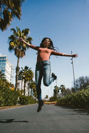 Teen girl walking happily through the streets.