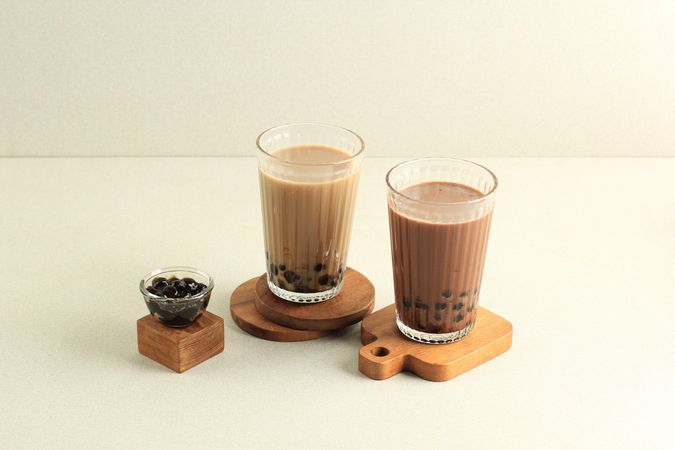 Boba tea on wooden coasters