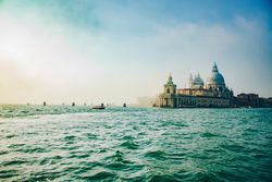 Waves on water surface and old building on shore