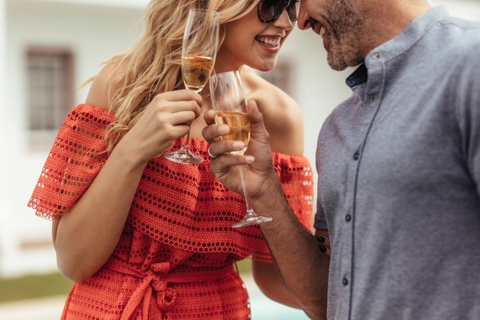 Romantic couple toasting glasses