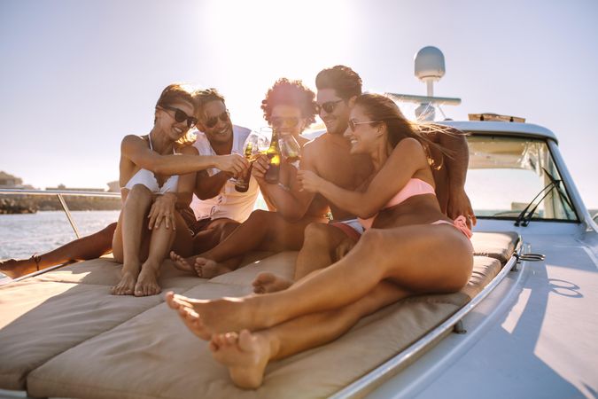 Attractive group of men and women enjoying private event on yacht