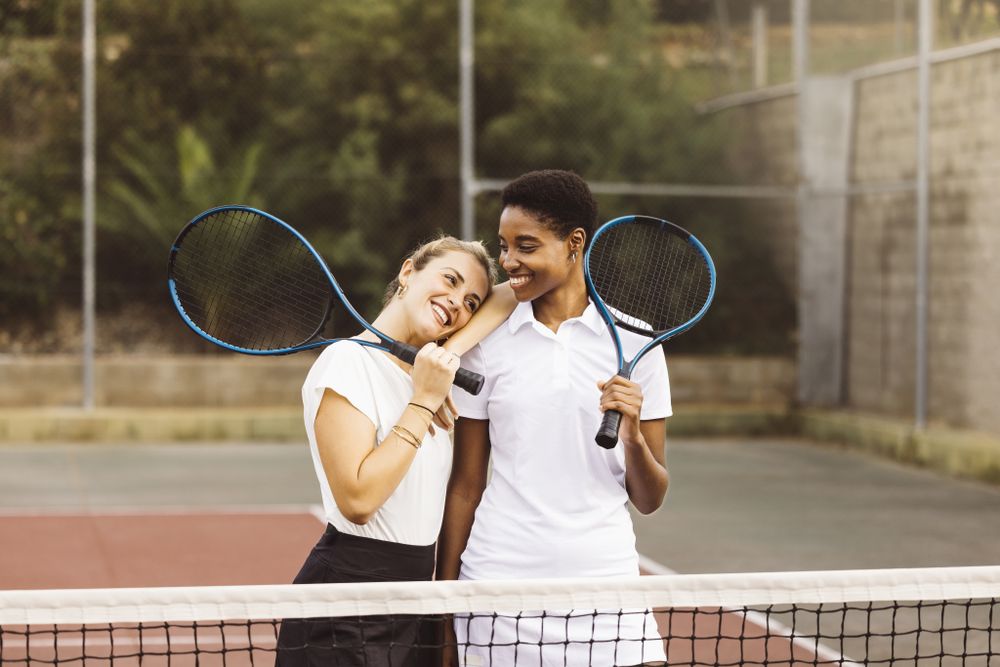 Portrait of two young women on a tennis court
