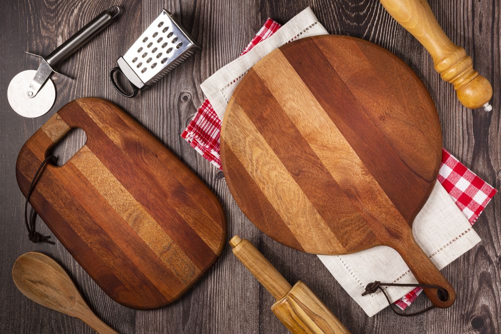Empty pizza board on rustic wooden table. Top view image.