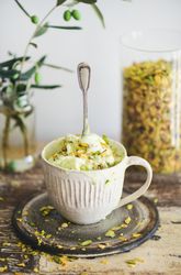 Cup of pistachio ice cream with spoon