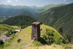 Tall old defensive building in majestic mountains in summer sunny day