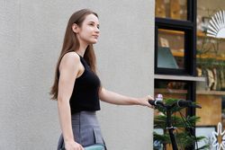 Woman walking with bicycle in the city