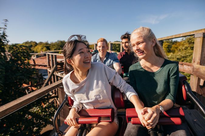 Two women feeling nervous on roller coaster